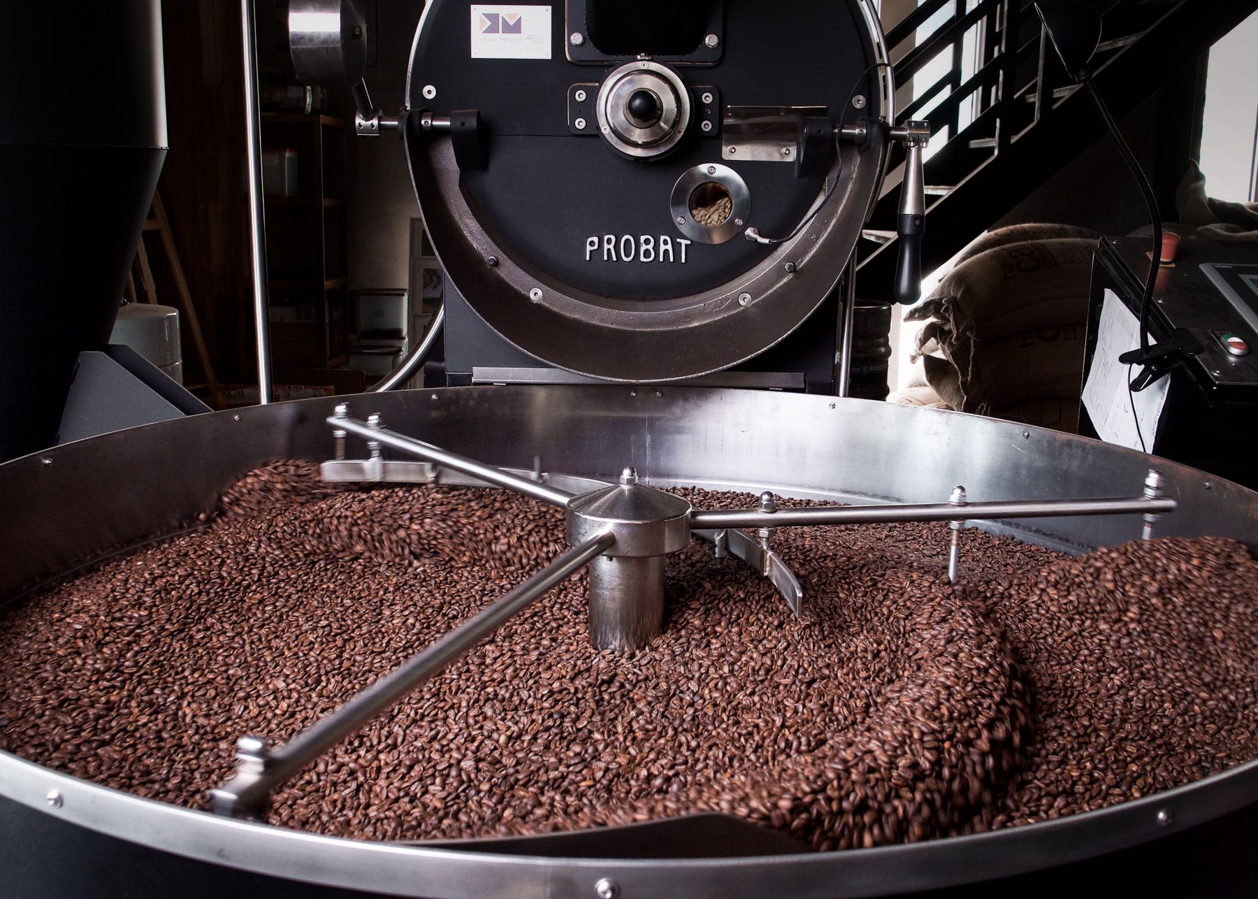 Roasted beans turning in a Probat drum roaster