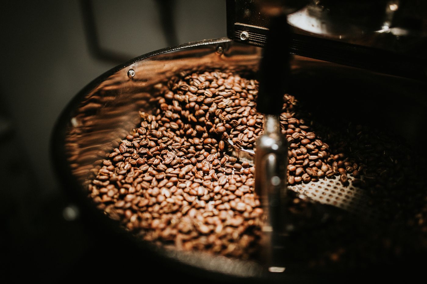 Beans tumbling, deep brown, in the roaster